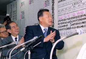 Mori claps as rose signs are attached for LDP winners